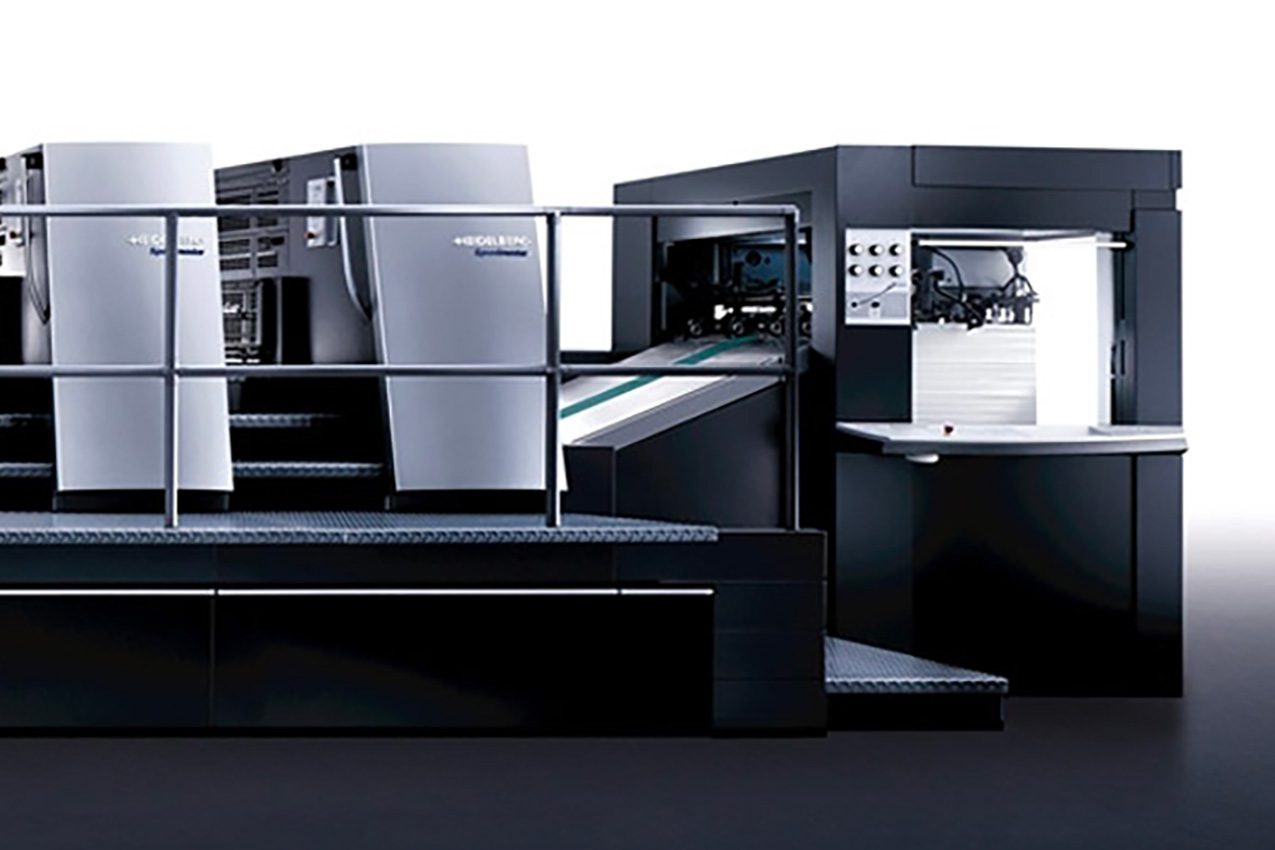 Man working in printing house with paper and paints